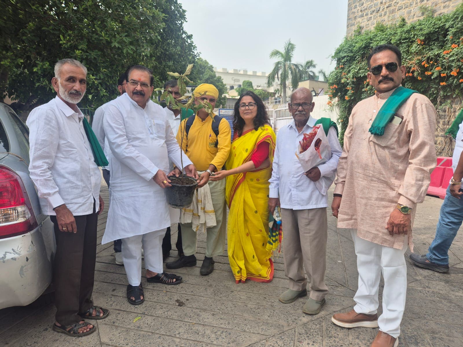 Mahacharya Sourabh J. Sarkar and Reena J. Sarkar presenting a plant to Shri Krishan Bir Choudhary with BKS representatives